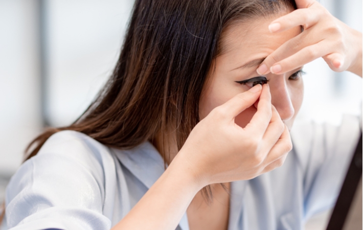 A woman putting in a set of contact lenses