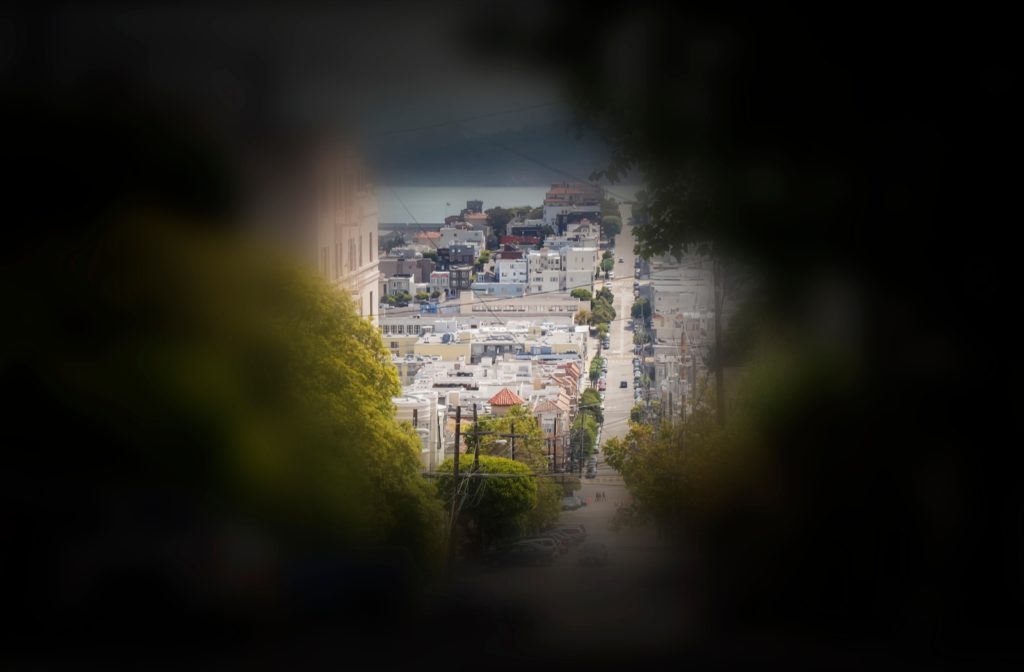 A example of what someone see's when suffering from tunnel vision, on top of a hill looking down a street with small buildings at the bottom