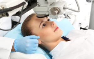 A woman laying down, prepared for laser eye surgery