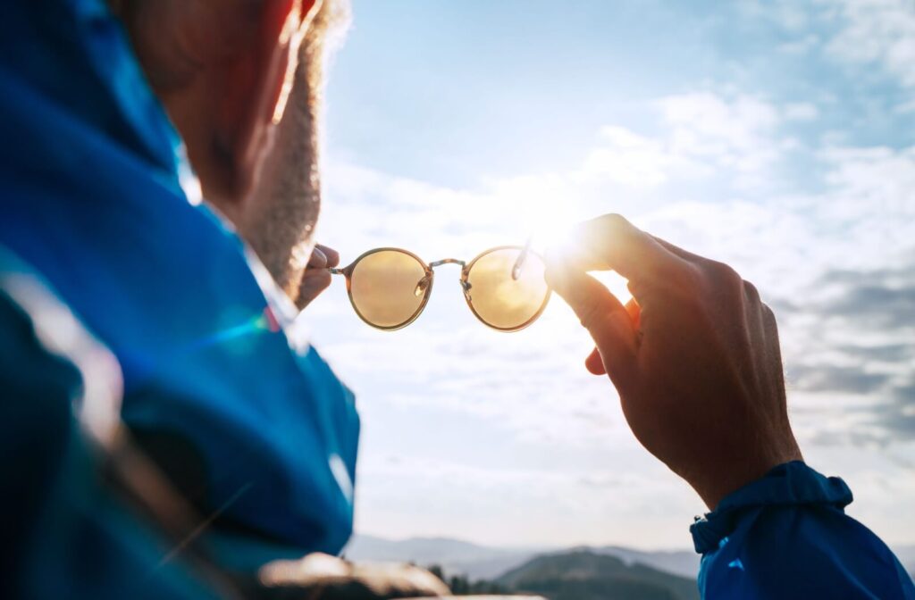 Polarized sunglasses held up to the sunlight, showing lens clarity and glare reduction.