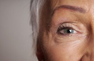 Close-up of an older woman’s eye, showing fine lines and detail around the eye area.